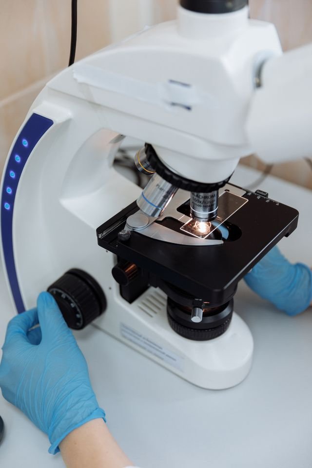 Close-up of a microscope being used for scientific research in a lab.